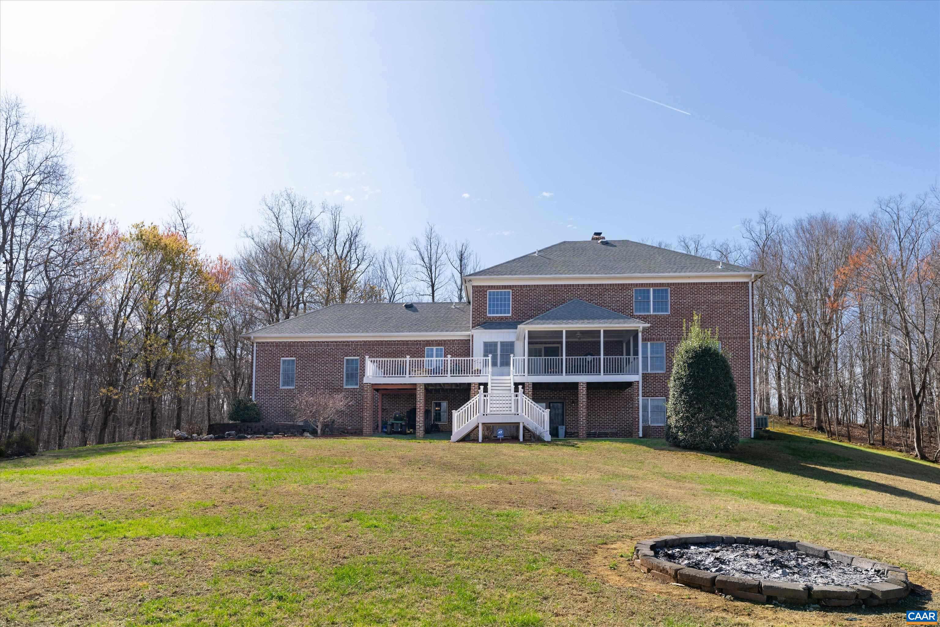 4444 Woods Edge Road Troy, VA 22974 - Photo 4 of 74 a front view of a house with a garden and yard