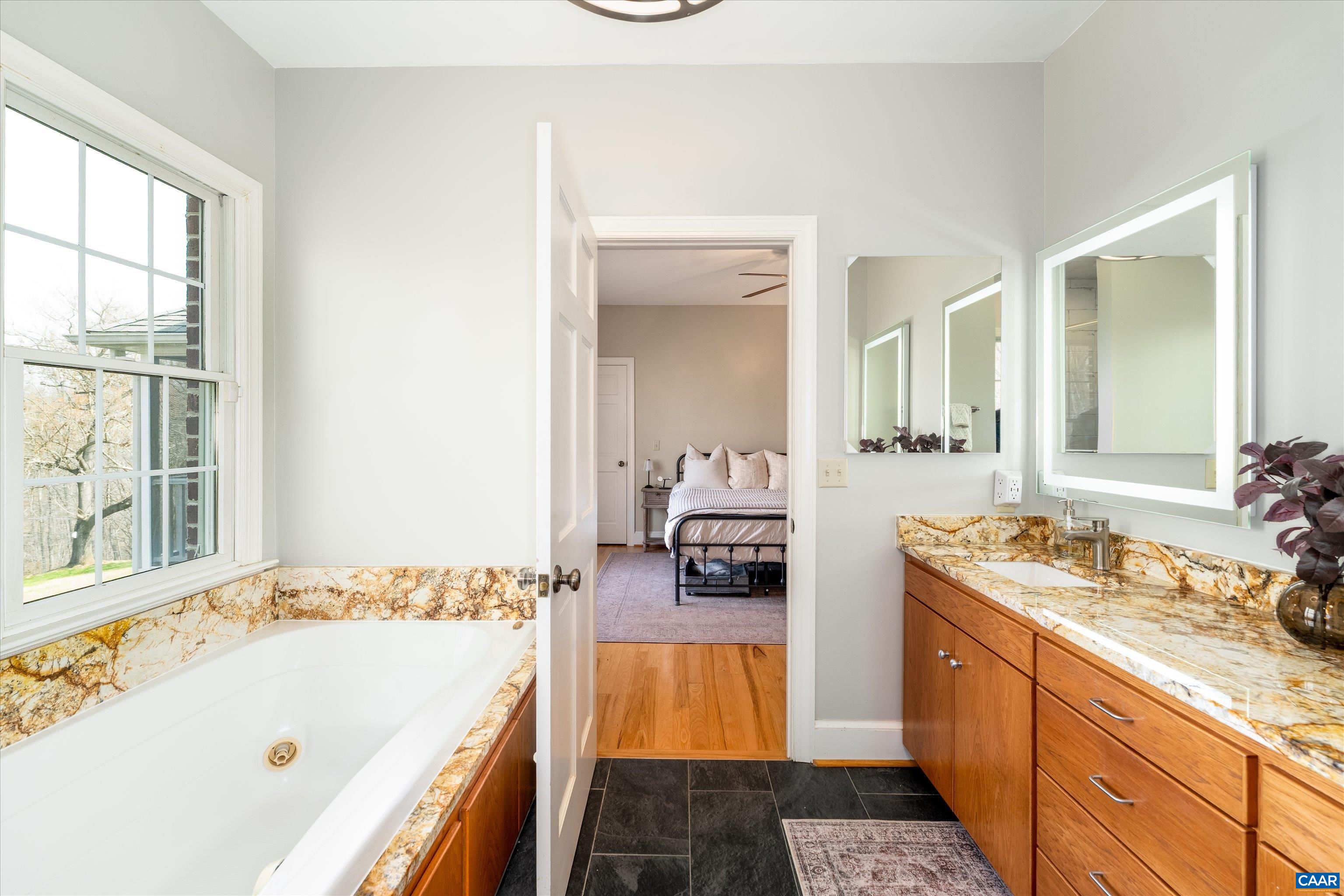 4444 Woods Edge Road Troy, VA 22974 - Photo 41 of 74 a spacious bathroom with a tub sink and mirror