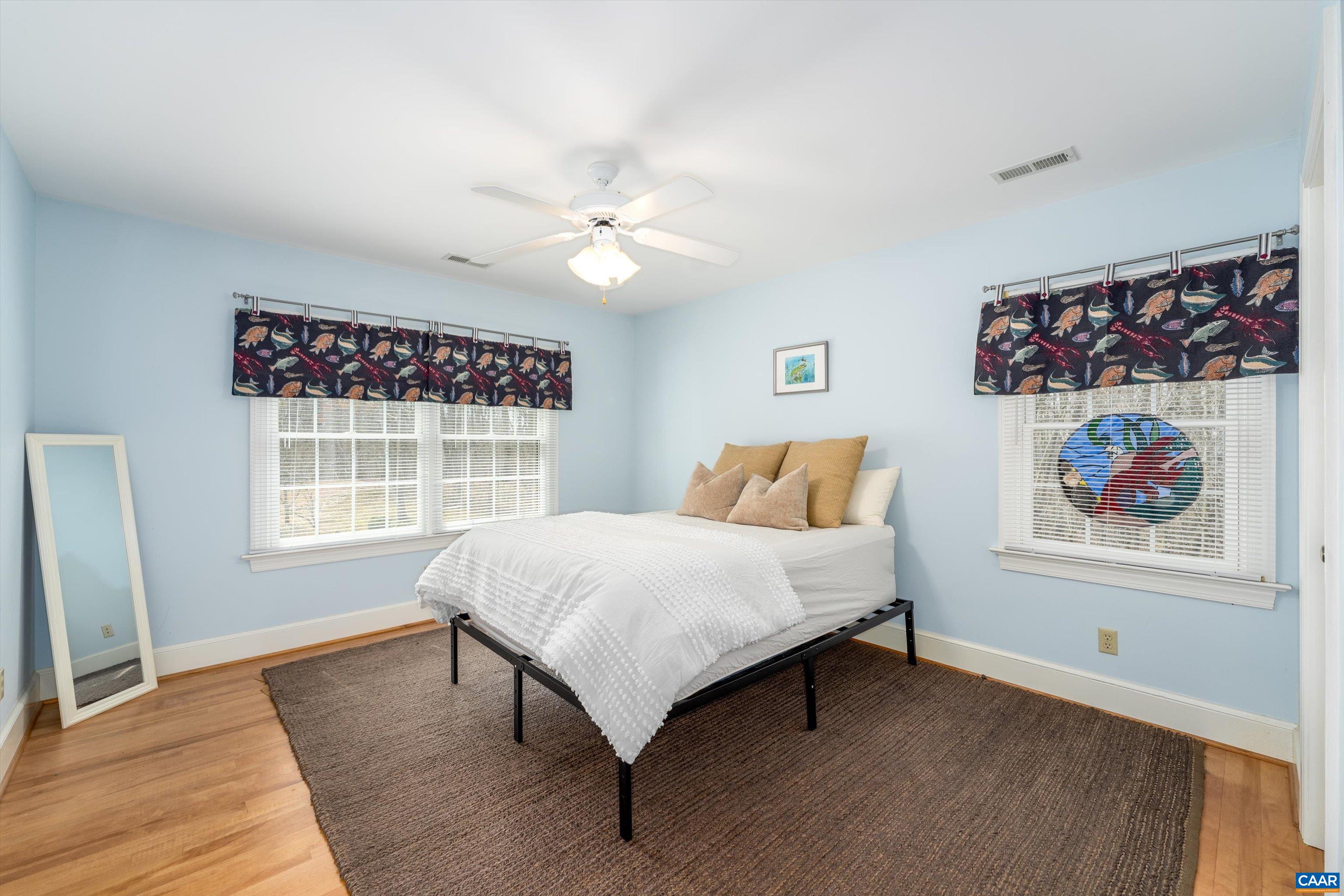 4444 Woods Edge Road Troy, VA 22974 - Photo 49 of 74 a bedroom with a bed painting on wall and a large window
