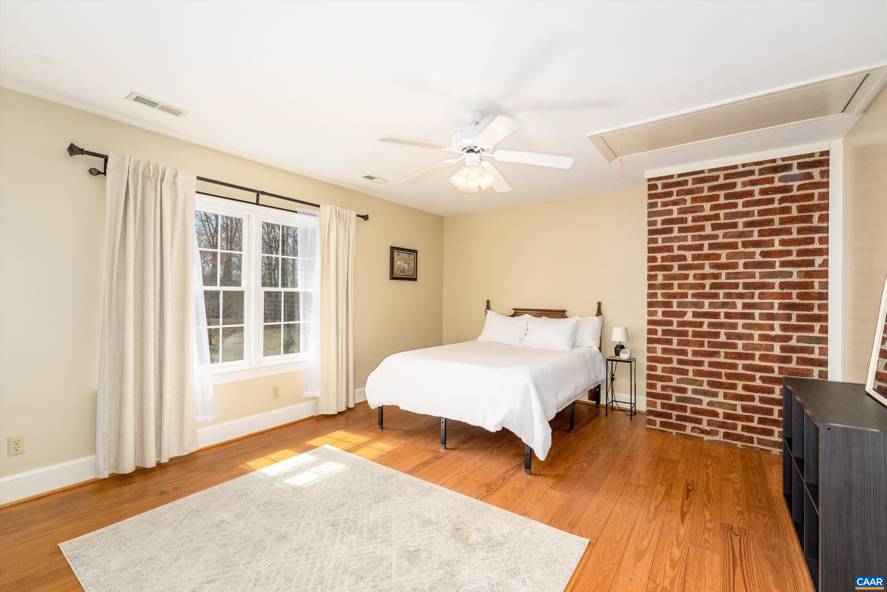 4444 Woods Edge Road Troy, VA 22974 - Photo 51 of 74 a spacious bedroom with a bed and wooden floor