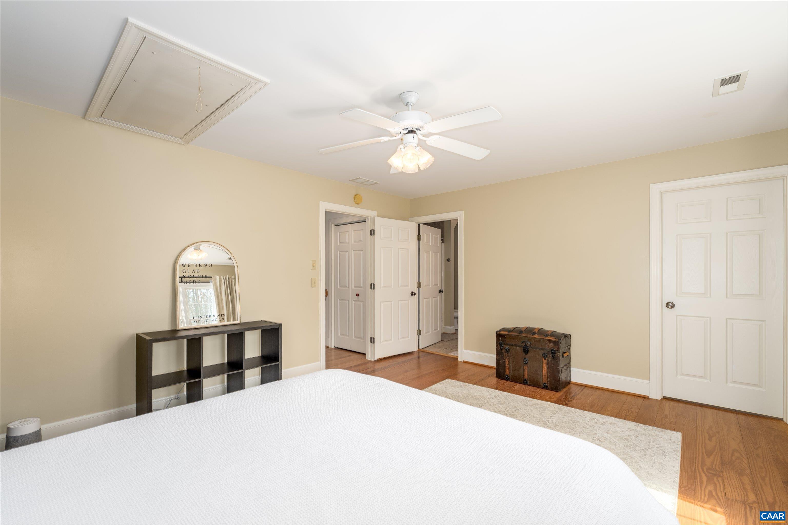 4444 Woods Edge Road Troy, VA 22974 - Photo 52 of 74 a bedroom with a bed and a chandelier