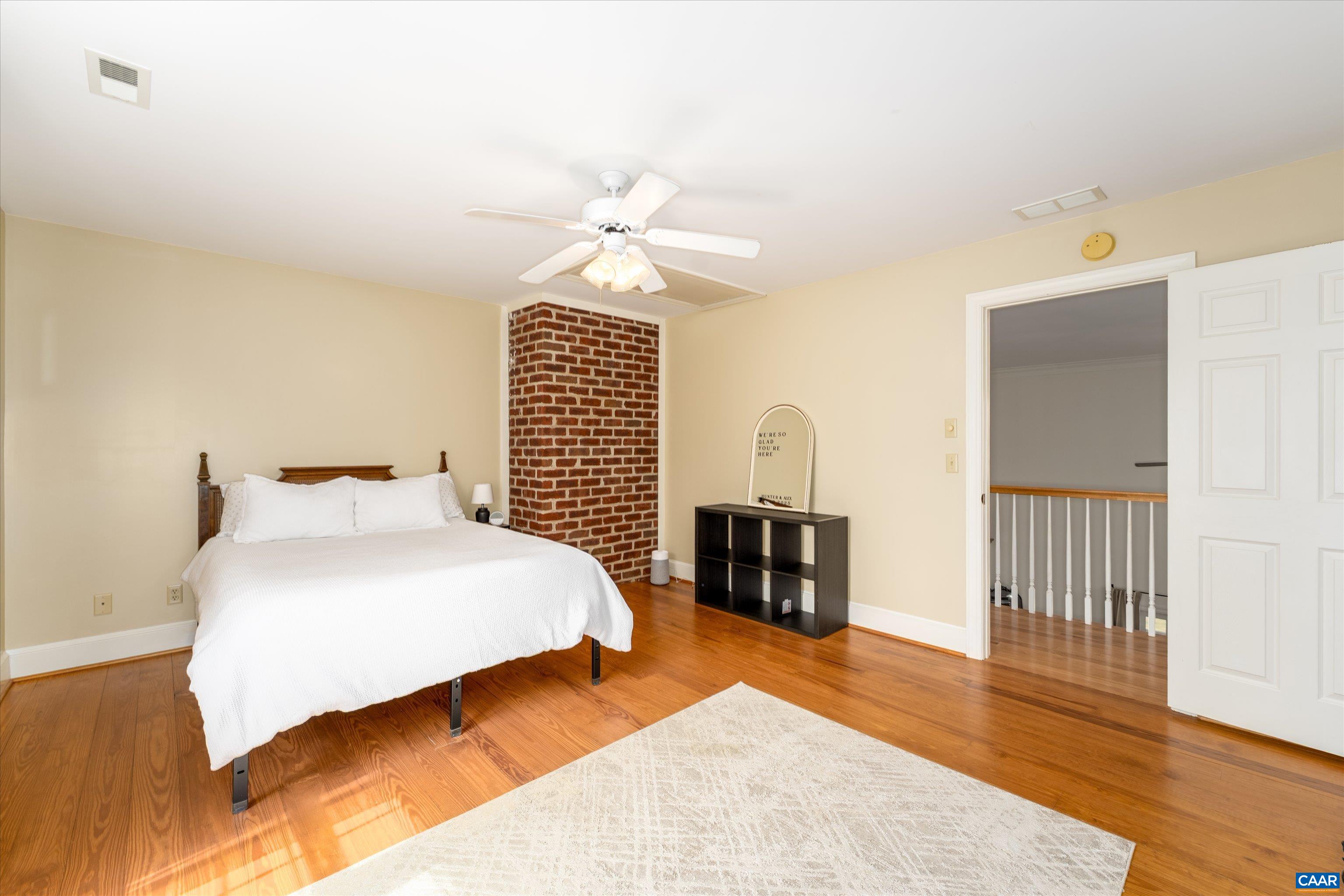 4444 Woods Edge Road Troy, VA 22974 - Photo 53 of 74 a bedroom with a bed and wooden floor