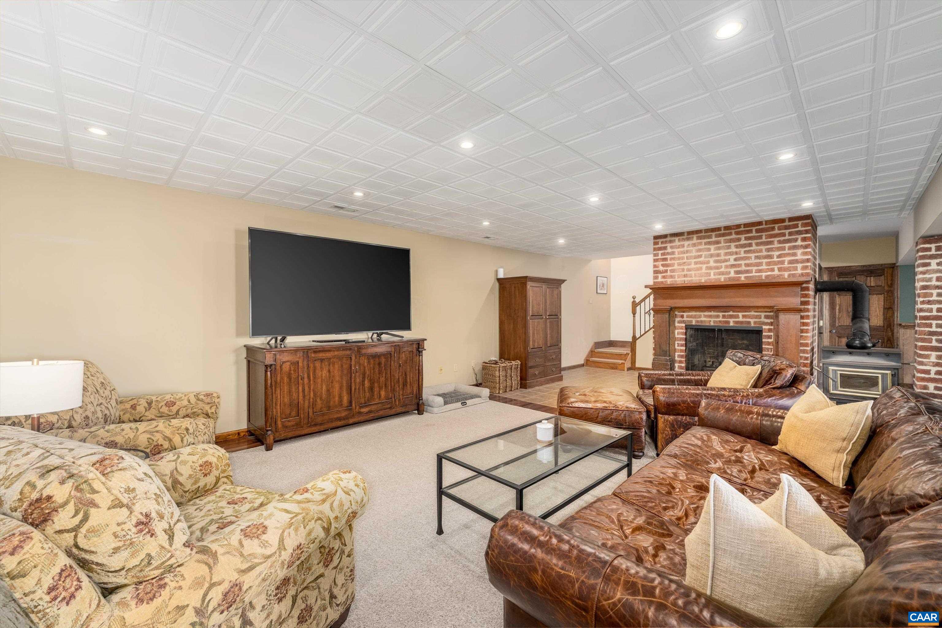 4444 Woods Edge Road Troy, VA 22974 - Photo 56 of 74 a living room with furniture and a flat screen tv