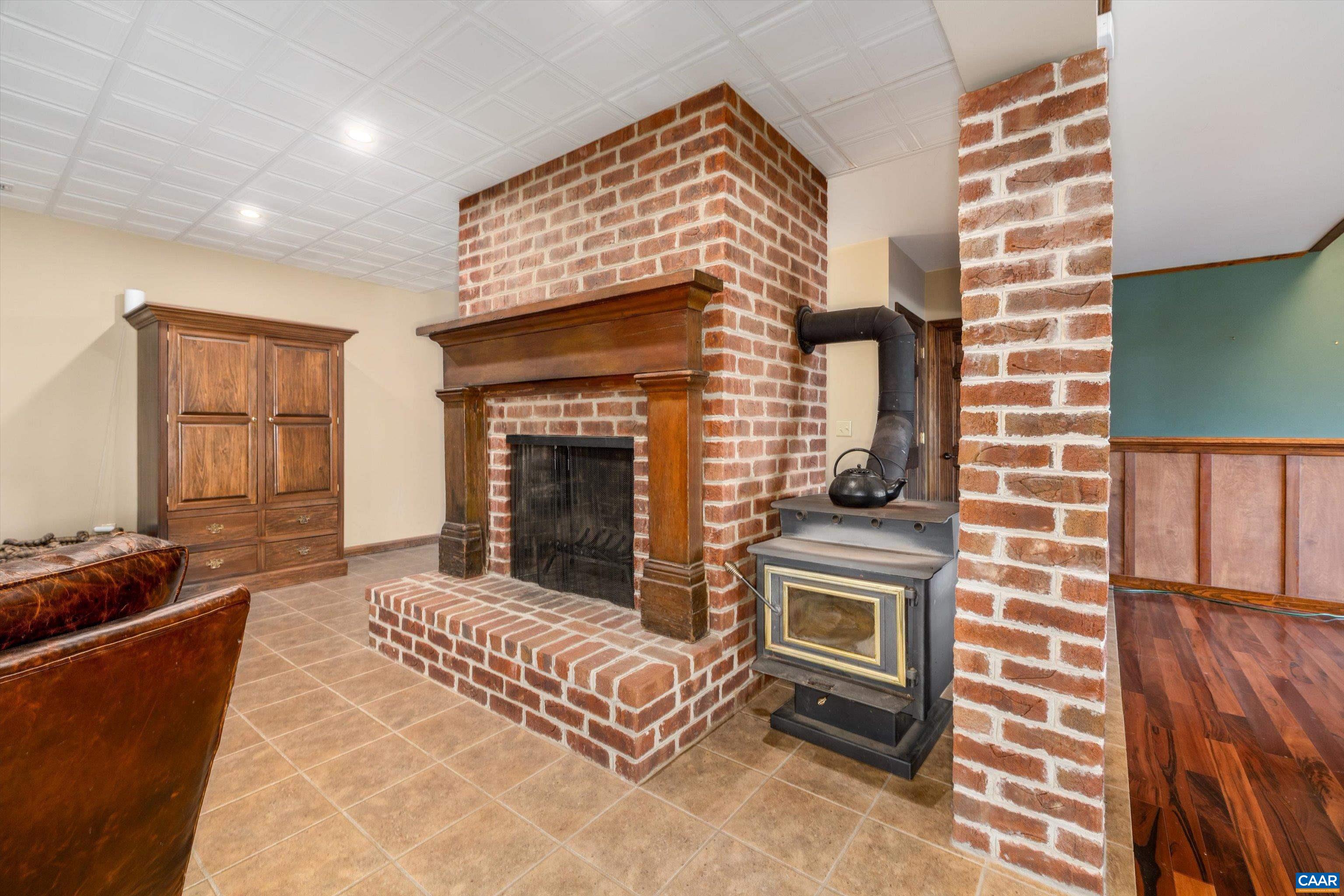 4444 Woods Edge Road Troy, VA 22974 - Photo 57 of 74 a living room with furniture and a fireplace