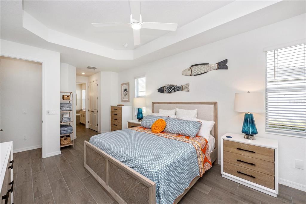 12950 Tulum Loop Venice, FL 34293 - Photo 28 of 98 a bedroom with a bed and wooden floor