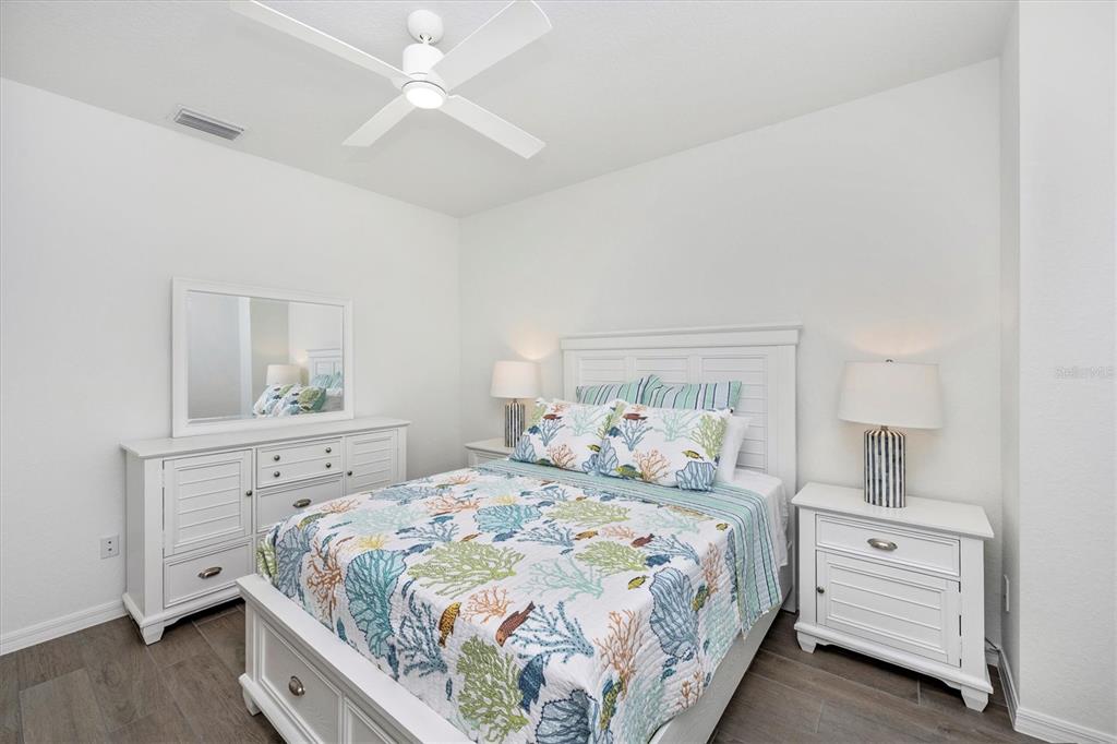 12950 Tulum Loop Venice, FL 34293 - Photo 33 of 98 a bedroom with a bed and a chandelier