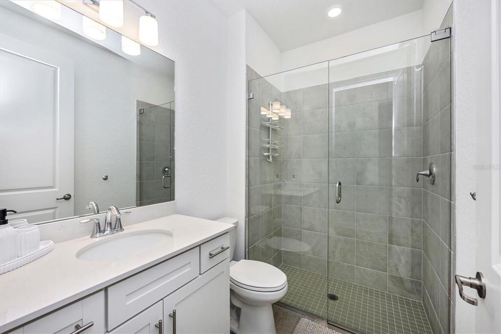 12950 Tulum Loop Venice, FL 34293 - Photo 37 of 98 a bathroom with a sink toilet and shower