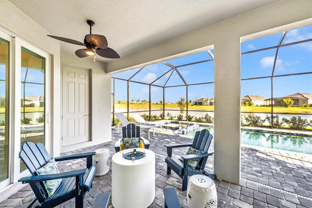 12950 Tulum Loop Venice, FL 34293 - Photo 46 of 98 a view of a dining room with furniture a chandelier and wooden floor