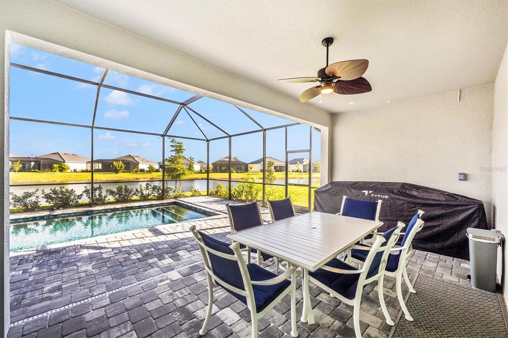 12950 Tulum Loop Venice, FL 34293 - Photo 51 of 98 a view of a patio with table and chairs