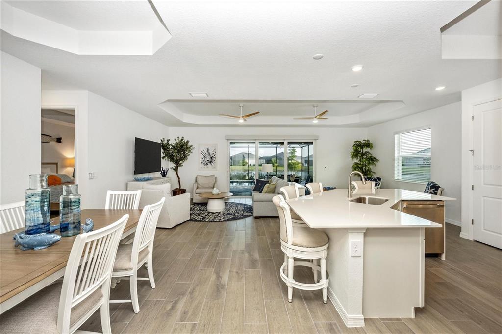 12950 Tulum Loop Venice, FL 34293 - Photo 6 of 98 a view of a dining room with furniture window and wooden floor