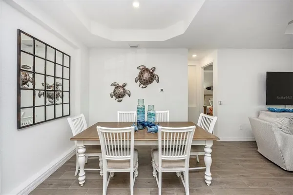a dining room with furniture window and wooden floor