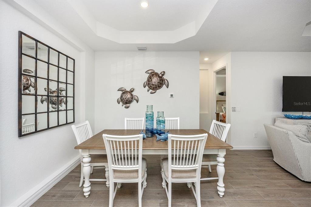 12950 Tulum Loop Venice, FL 34293 - Photo 7 of 98 a view of a dining room with furniture window and wooden floor
