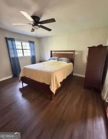 a bed sitting in a bedroom next to a window