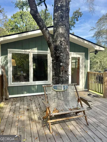 a view of a house with backyard sitting area with furniture