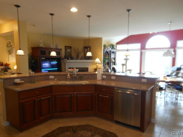48 Inverness Lane Easton, PA 18045 - Photo 12 of 28 a kitchen with a sink stove and a wooden cabinets