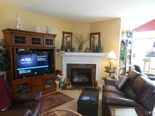 48 Inverness Lane Easton, PA 18045 - Photo 13 of 28 a living room with furniture a flat screen tv and a fireplace