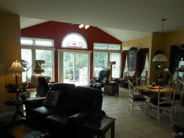 48 Inverness Lane Easton, PA 18045 - Photo 15 of 28 a living room with furniture a floor to ceiling window and a flat screen tv