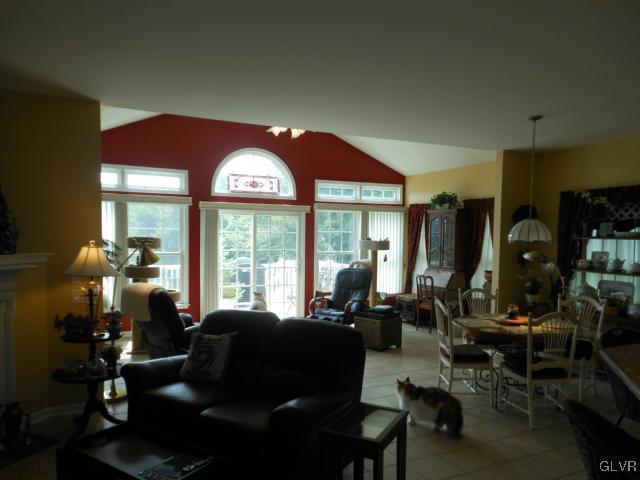 48 Inverness Lane Easton, PA 18045 - Photo 16 of 28 a living room with furniture a floor to ceiling window and a flat screen tv