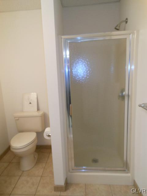 48 Inverness Lane Easton, PA 18045 - Photo 25 of 28 a bathroom with a granite countertop toilet and a shower