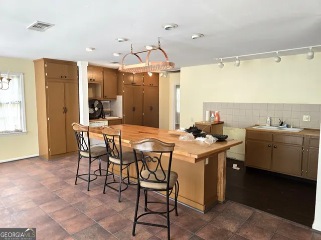 a kitchen with a table and chairs