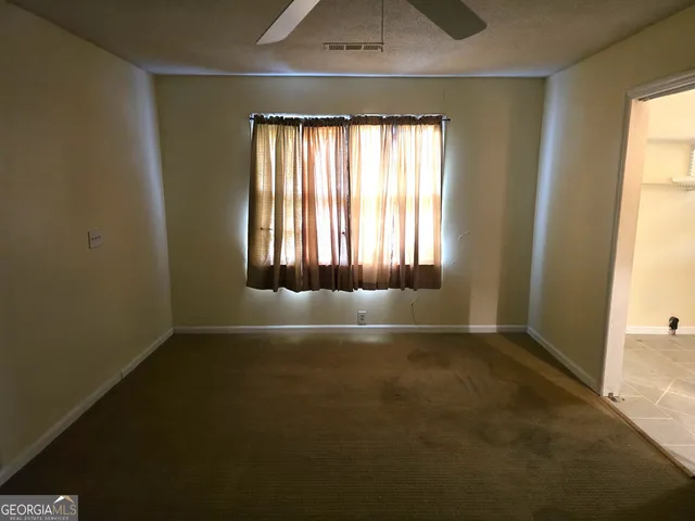 an empty room with a empty space and windows