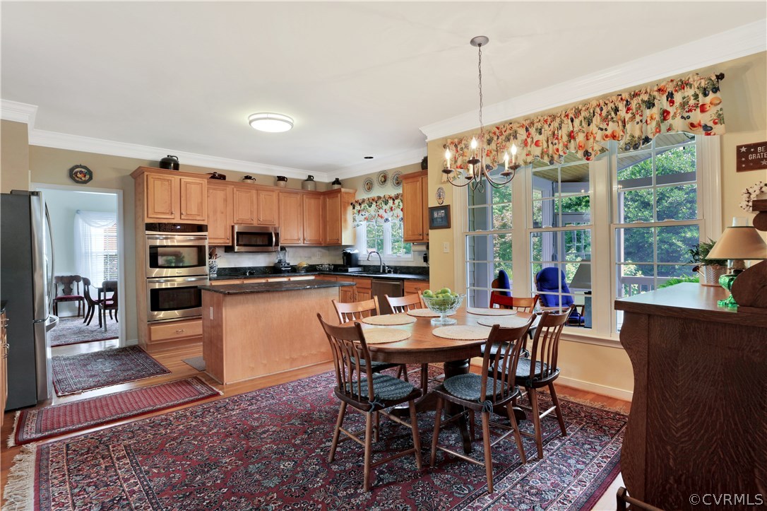1201 Goswick Ridge Road Midlothian, VA 23114 - Photo 14 of 32 a dining room with stainless steel appliances a dining table chairs and a rug