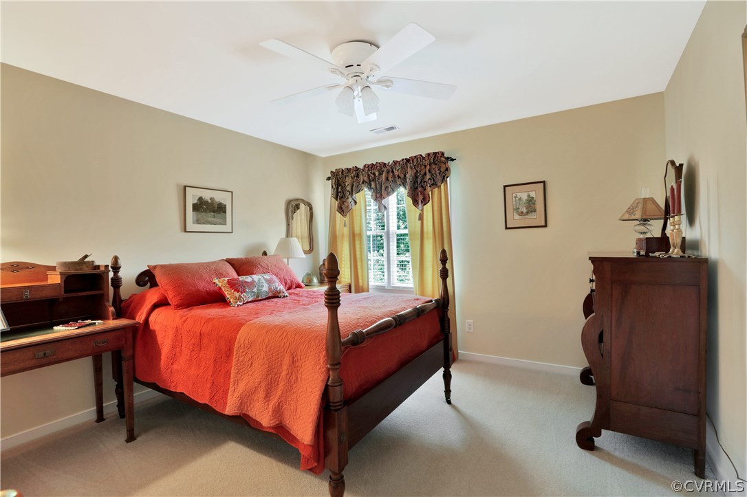 1201 Goswick Ridge Road Midlothian, VA 23114 - Photo 21 of 32 a bedroom with a bed and a chandelier