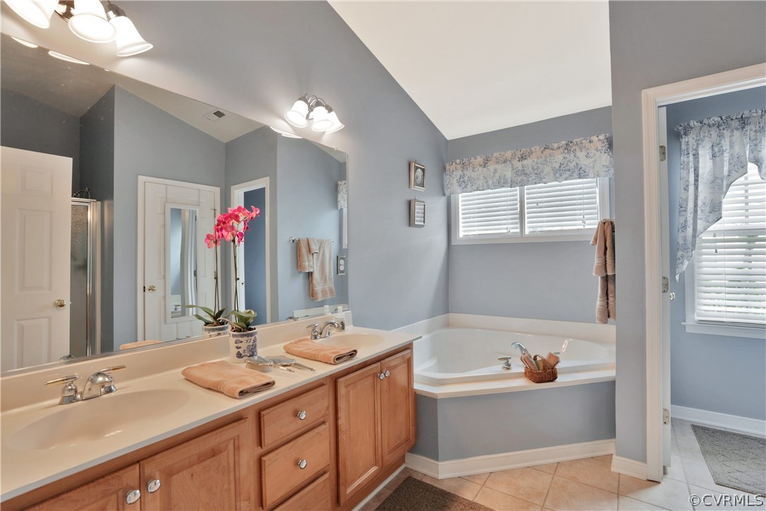 1201 Goswick Ridge Road Midlothian, VA 23114 - Photo 25 of 32 a bathroom with a bathtub a double vanity sink and mirror