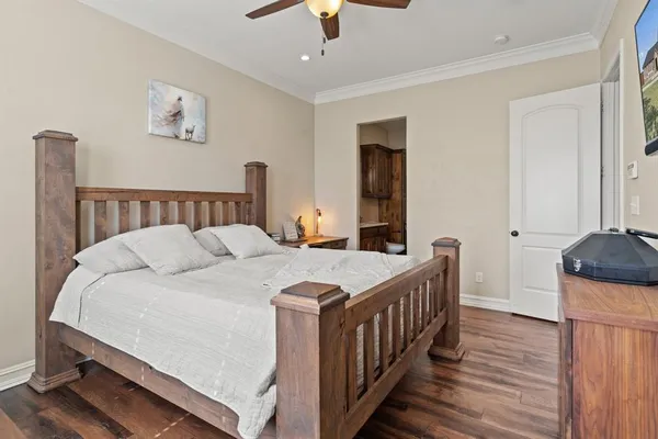 a bedroom with a bed and a chandelier