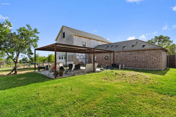 a view of a house with a yard and sitting area