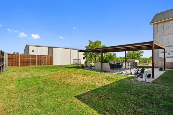 a view of a backyard with sitting area