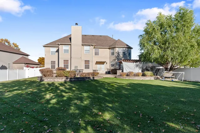 a front view of house with yard outdoor seating and green space