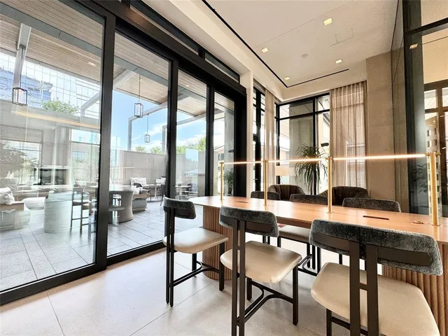 a view of a dining room with furniture large windows and wooden floor