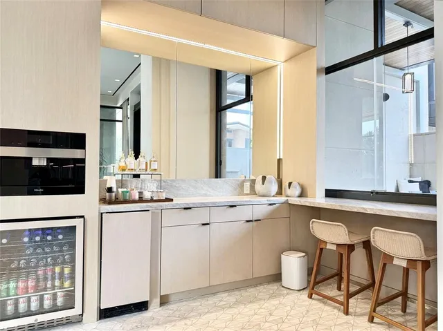 a large kitchen with a sink and cabinets