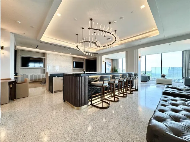 a view of a livingroom with furniture and a kitchen