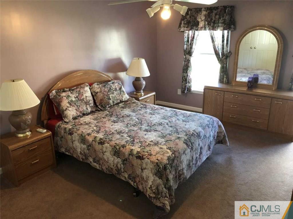 36 Ferris Road Edison, NJ 08817 - Photo 14 of 22 a bed sitting in a bedroom next to a window