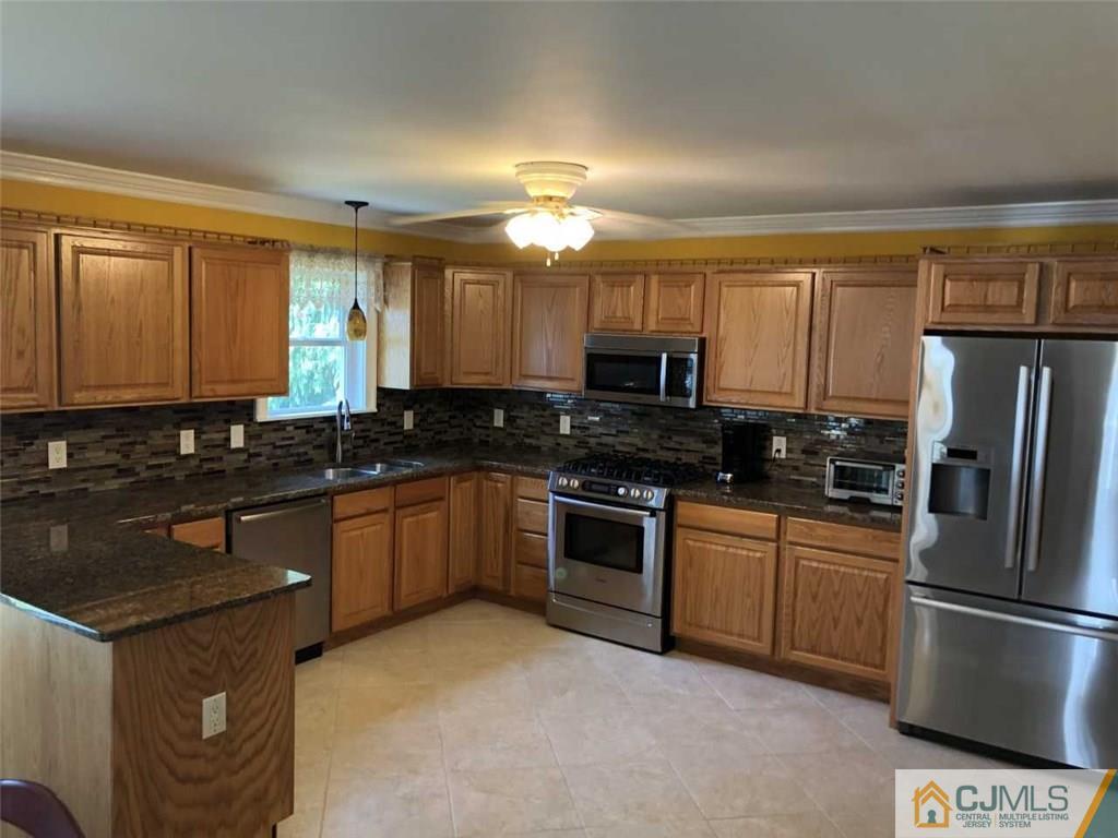 36 Ferris Road Edison, NJ 08817 - Photo 3 of 22 a kitchen with granite countertop a refrigerator stove top oven and sink