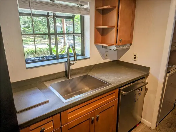 a view of a kitchen with a sink and windows