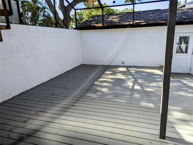 a view of a room with wooden floor
