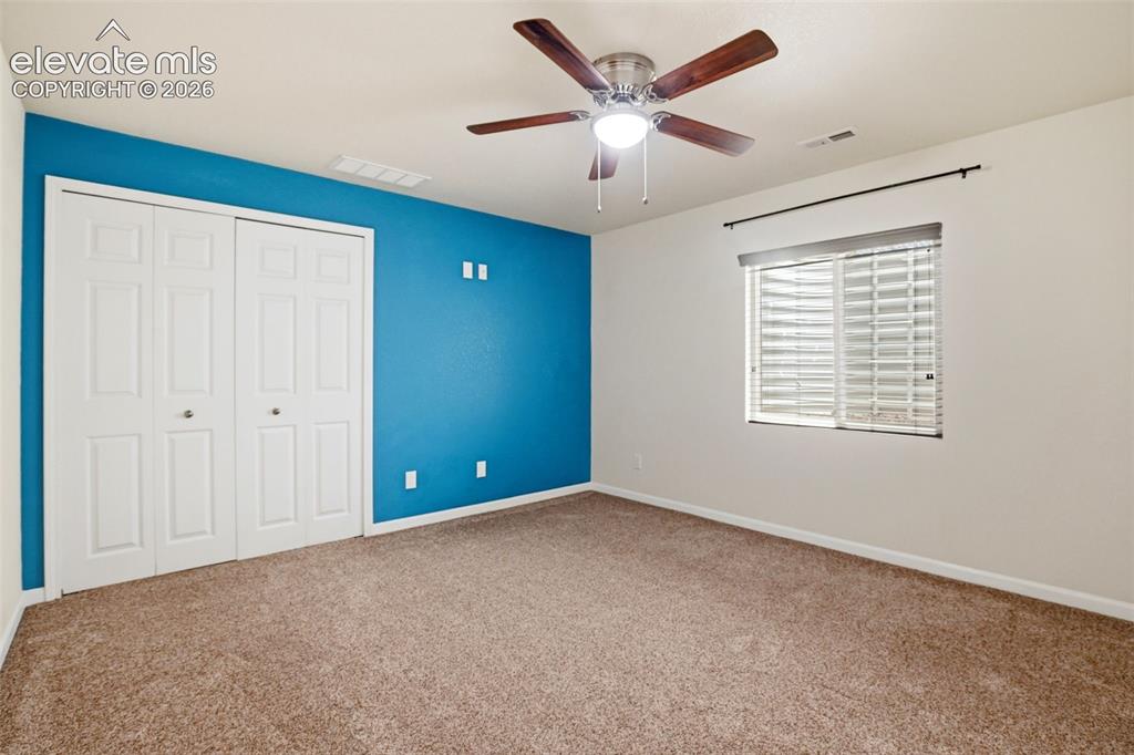 7806 Dutch Loop Colorado Springs, CO 80925 - Photo 23 of 41 a view of an empty room with a window