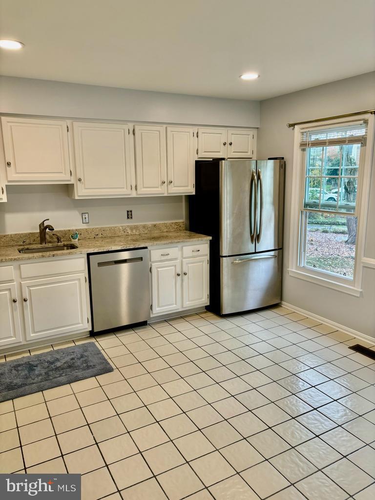 6803 Wild Rose Court Springfield, VA 22152 - Photo 11 of 49 a kitchen with a cabinets a sink and a stove