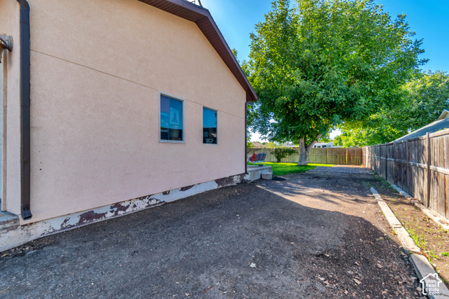 432 South 600 East Payson, UT 84651 - Photo 4 of 34 Exterior stucco siding with two windows and a brown gutter system