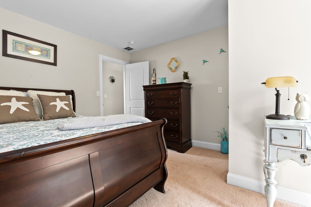 24 Old Rowley Road Newbury, MA 01951 - Photo 24 of 42 a bedroom with a bed and dresser