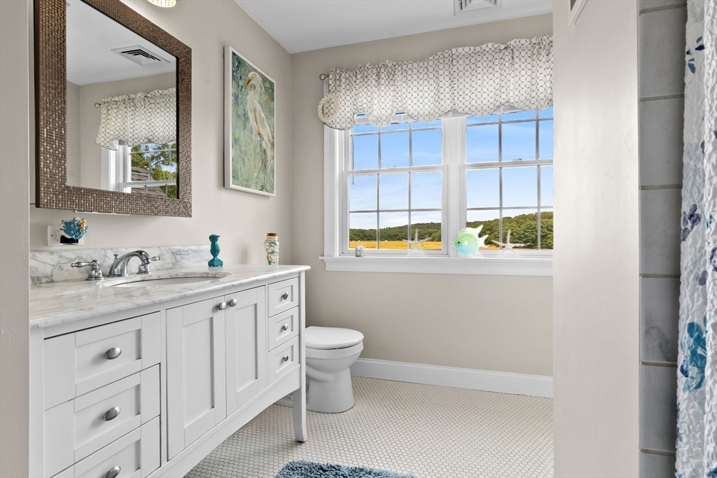 24 Old Rowley Road Newbury, MA 01951 - Photo 28 of 42 a bathroom with a granite countertop sink and a mirror