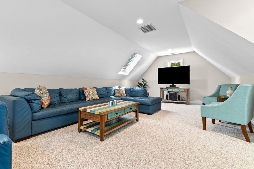 24 Old Rowley Road Newbury, MA 01951 - Photo 30 of 42 a living room with furniture and a flat screen tv