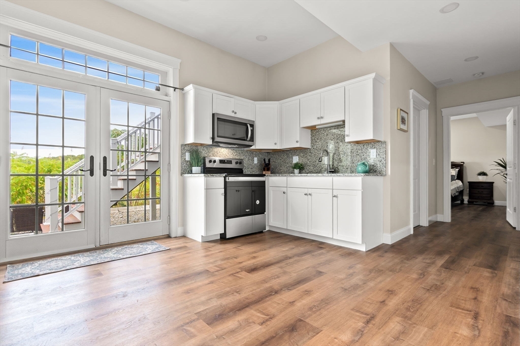 24 Old Rowley Road Newbury, MA 01951 - Photo 31 of 42 a kitchen with stainless steel appliances a stove top oven a sink a refrigerator a window