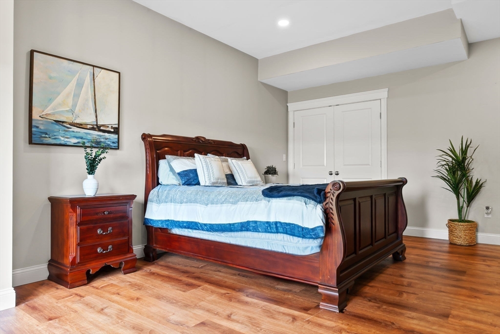 24 Old Rowley Road Newbury, MA 01951 - Photo 36 of 42 a bedroom with a bed and wooden floor