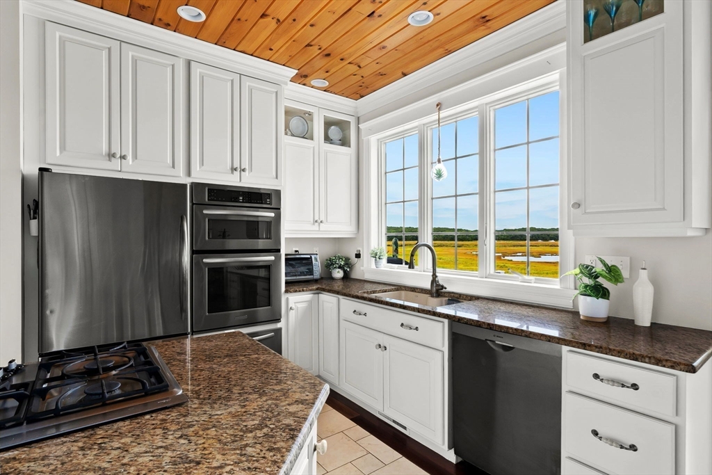 24 Old Rowley Road Newbury, MA 01951 - Photo 6 of 42 a kitchen with stainless steel appliances granite countertop a stove a sink and a refrigerator