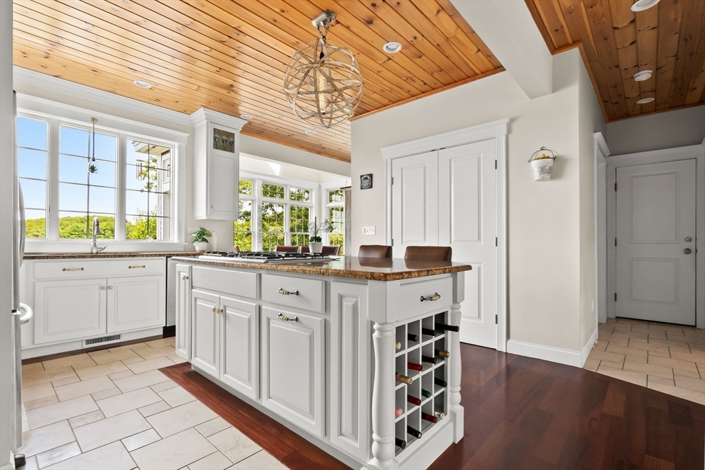 24 Old Rowley Road Newbury, MA 01951 - Photo 7 of 42 a kitchen with stainless steel appliances a white cabinets and wooden floor
