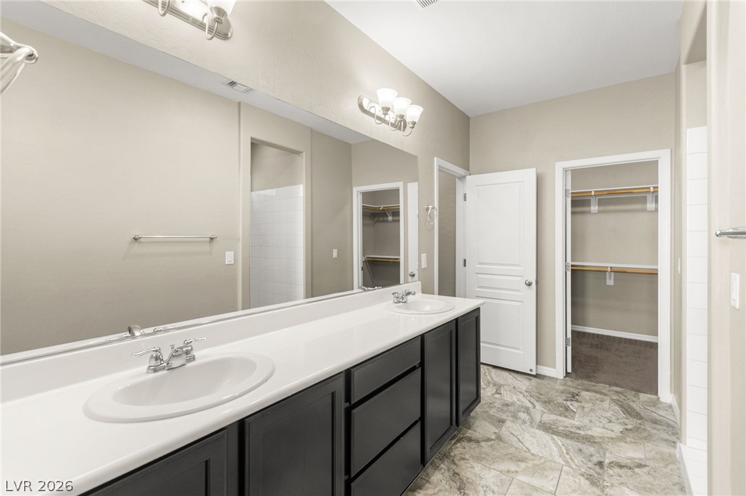 11048 Prairie Grove Road Las Vegas, NV 89179 - Photo 26 of 75 Double vanities and spacious walk-in closets define this pristine primary bathroom.